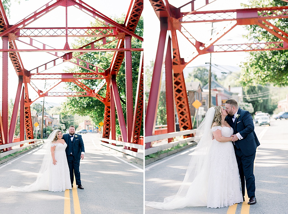 bride and groom kissing under red bridge