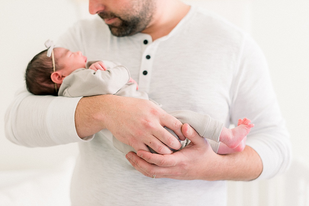 father holding newborn daughter
