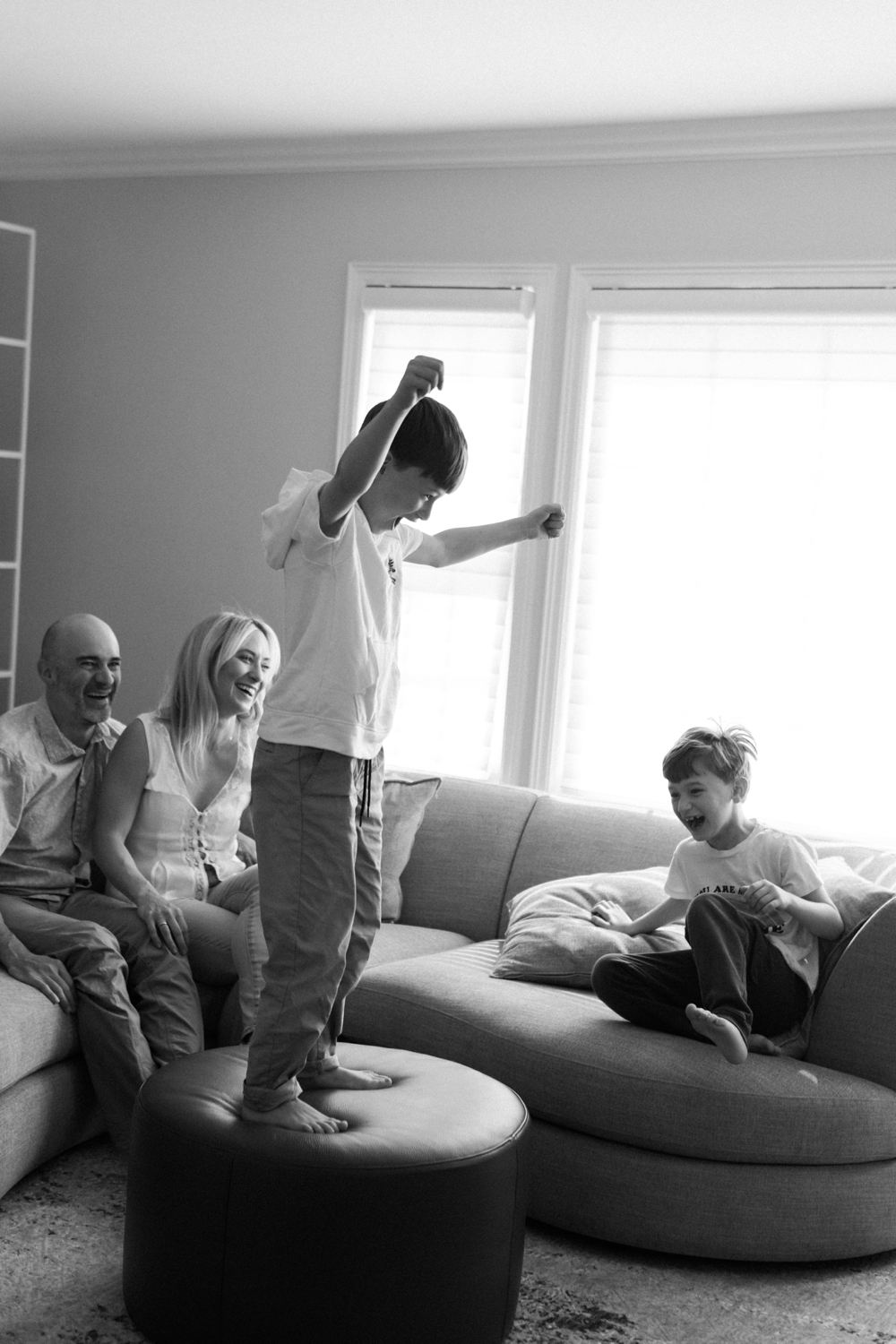 Family laughing together at home.