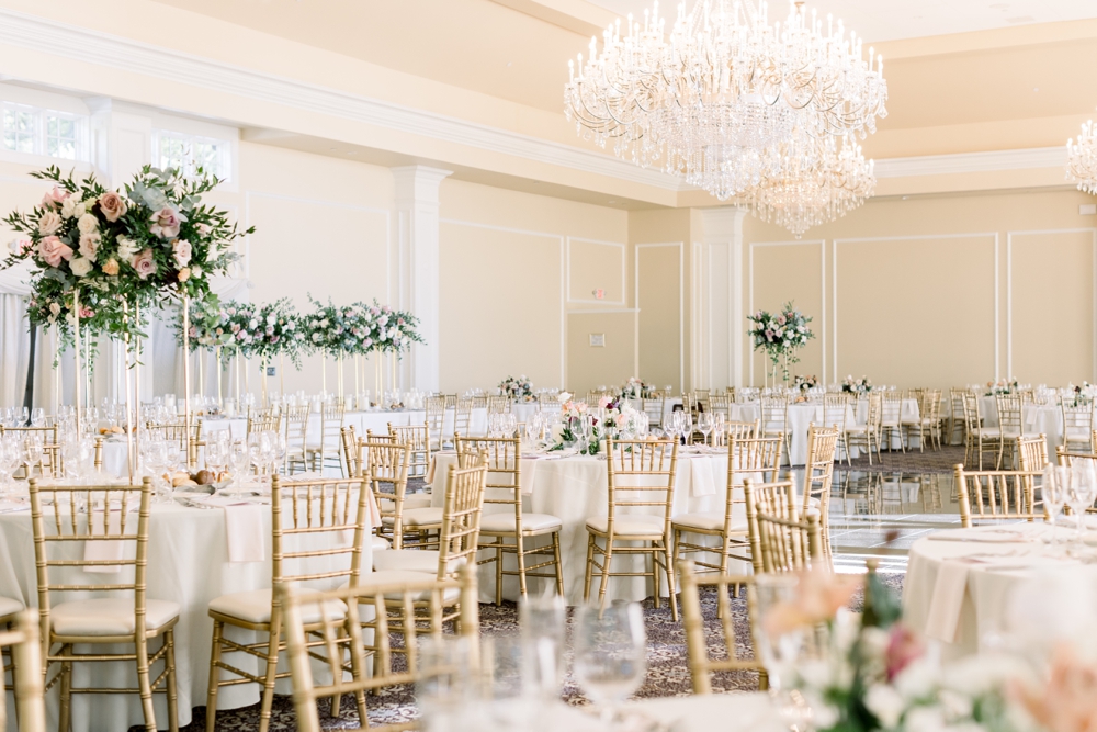 Details of one of the best Westchester wedding venues set up for a reception with crystal chandeliers and tall floral centerpieces