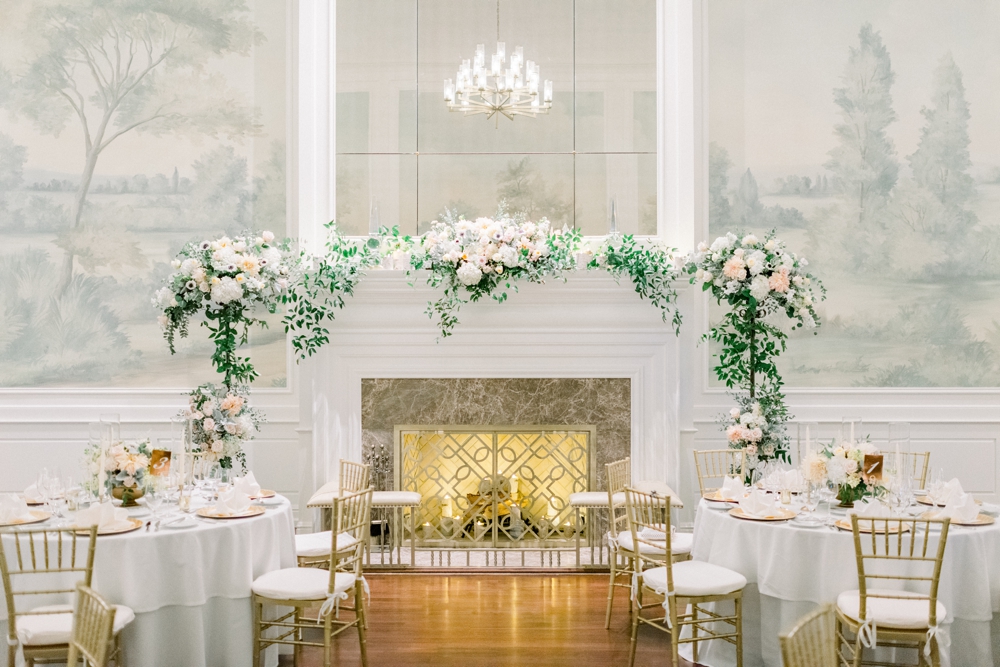 One of the best Westchester wedding venues with an ornate fireplace framed in white florals